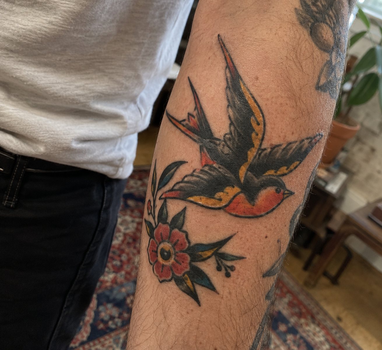 Illustrative colorful swallow and floral tattoo